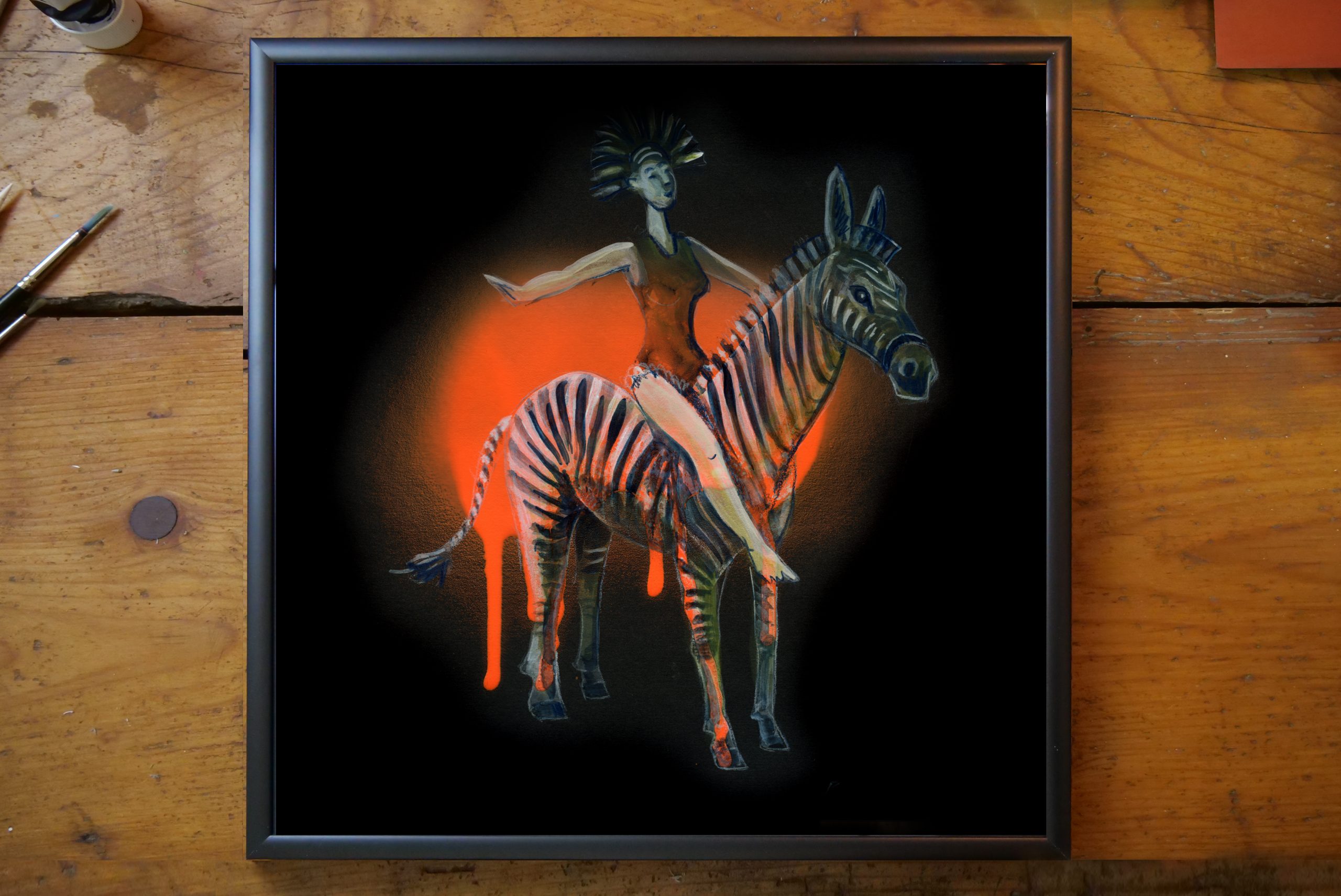 A woman sitting on a zebra